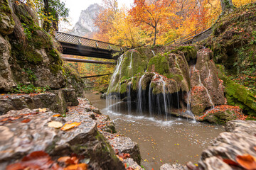 Bigar Waterfall in the Romanian mountains - amazing view of one of the most beautiful waterfalls in Europe during an autumn day with great fall colors