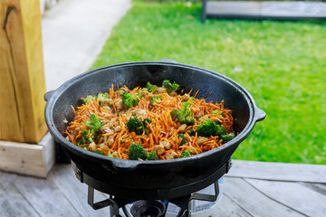 A large cauldron with a cooked healthy vegetable for party.
