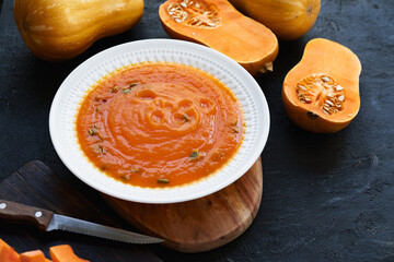Homemade pumpkin soup on a black table