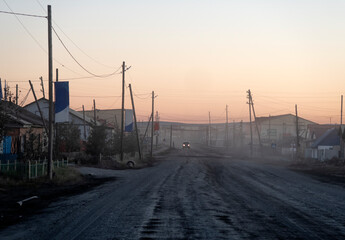 A wooden house with Windows behind a fence stands at a fork in the road .
wooden houses in the city of Batagay. Yakutia. Russia.
