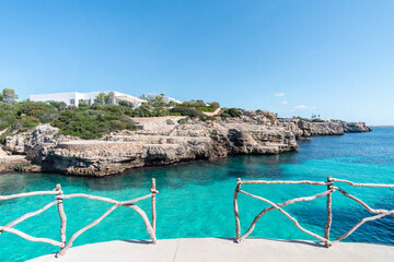 Turquoise waters of Cala en Brut, beach of Minorca, Balearic Islands in Spain