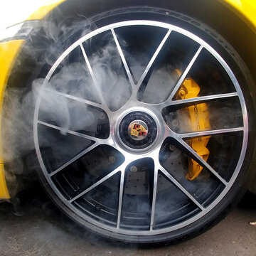 Russia, Moscow - May 04, 2019: Yellow Porsche 911 Turbo S Light Alloy Wheels With Carbon Ceramic Brakes And Smoke From It. Close Up, Square Image