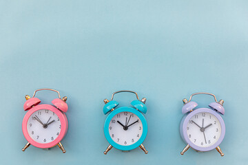 Simply minimal design three ringing twin bell classic alarm clock Isolated on blue pastel...