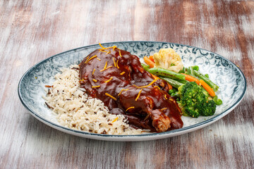 Duck in orange sauce with blanched vegetables and rice