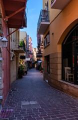 Beautiful view of empty and colorful narrow streets of old mediterranean town. Bright sunlight and deep shadows. No people. Chania, Crete, Greece