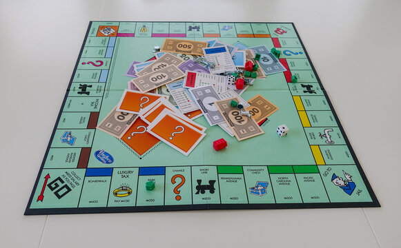 Orlando, FL/USA-12/20/19:  Pieces for the game Monopoly by Hasbro on a white background.  Concept business, finance, banking, real estate, and property.