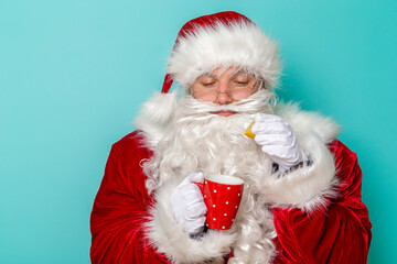 Santa adding lemon into cup of tea