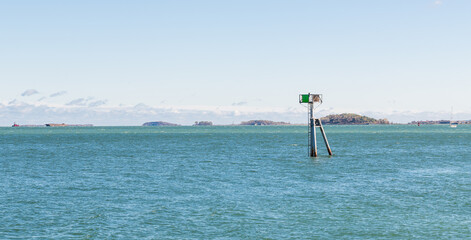 Buoy and pole in the ocean harbor, Castle Island, Boston