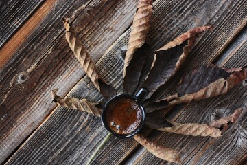 Americano coffee and brown chestnut leaf macro