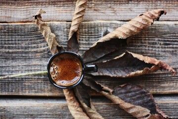 Americano coffee and brown chestnut leaf macro