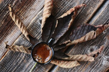 Americano coffee and brown chestnut leaf macro