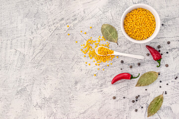Yellow Lentils with spices with on white background. Healthy lifestyle. Lentil soup ingredients . Flat lay.