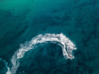 Aerial view of a jet ski cruising at full speed. Fun and holidays, water sport. Sea and waves