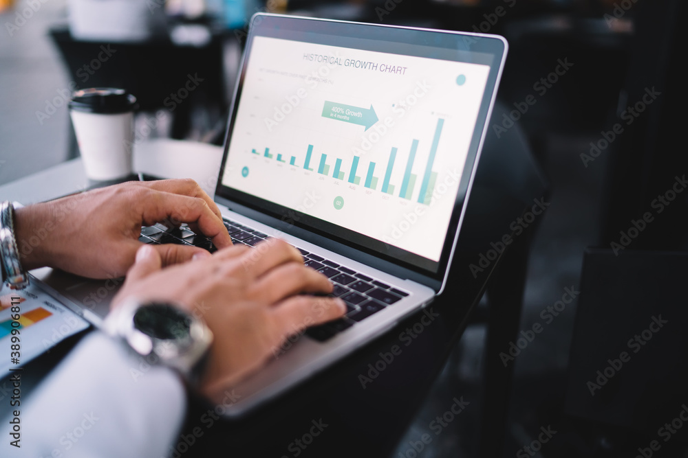 Aufkleber cropped male boss analyzing revenue graph charts displayed on modern laptop computer during time for