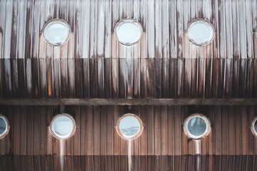 circular porthole windows on wooden building