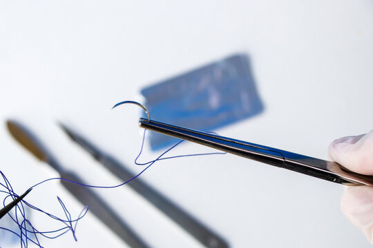Surgery operation equipment, scalpel, knife, needle and suture. Studio shoot.