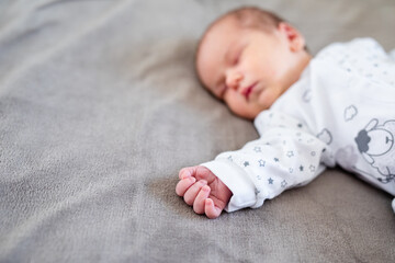 Baby boy sleeping first days of life. Cute little newborn child sleeping peacefully