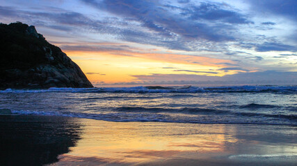 sun rising from behind a mountain on Francisco do Sul beach