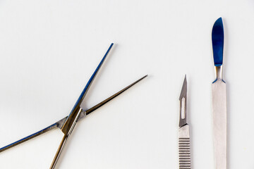 Surgery blade on the sterile table, scalpel close-up, surgery knife and tweezers