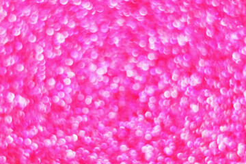 Glitter splash and lens flare on pink shiny trendy background. Sequins. Festive background for your projects. Blurred pink festive bokeh lights. Christmas festive time concept on background.