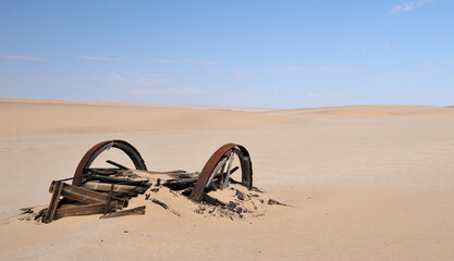A wagon used by the diamond miners disintegrating in the sand of the Namib Desert