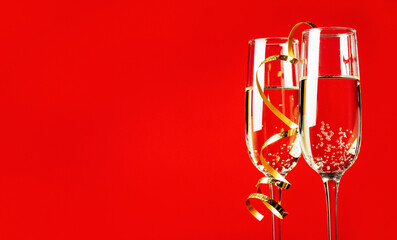 Champagne glasses on a red background
