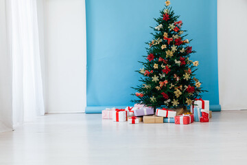 decor garland Christmas tree with gifts for the new year interior