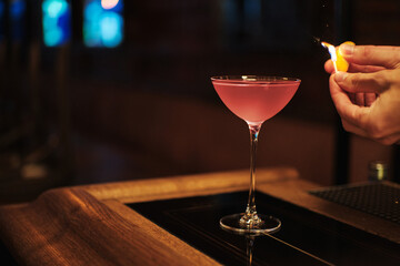 Pink Cosmopolitan vodka cocktail with flame