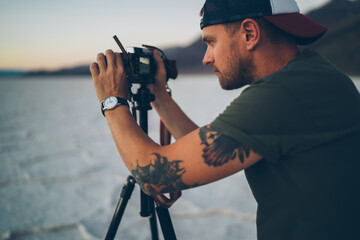 Male photographer shooting landscape in desert
