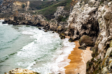 Mountains of steel and stones on the seashore. Wild beach. holidays, privacy, 