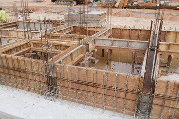 KUALA LUMPUR, MALAYSIA -MARCH 5, 2020: Building ground beam under construction using temporary timber plywood formwork at the site. Reinforced by the reinforcement steel to strengthen the structure. 