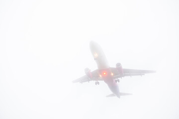 view of landing plane in misty weather
