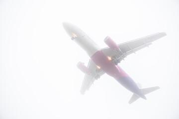 view of landing plane in misty weather