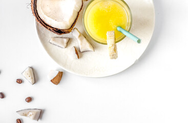 cocktail with coconut on white background top view