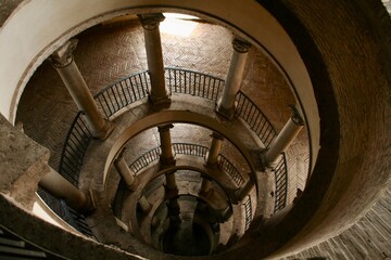 Spiral rounded ramp stairs. Into the dark, into the light. Rising up, going down. Mystic lighting....