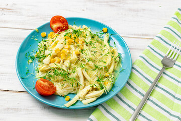 Spaghetti with squid and cheese in a creamy sauce on a wooden background.