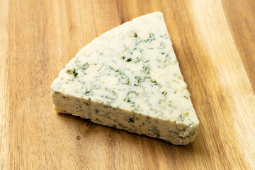 Blue cheese on a wooden background.