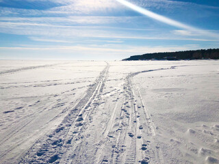 Fototapeta na wymiar White winter road in a snow field