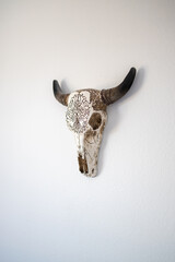 Southwestern Decorative Cow Skull Head Hanging on White Bedroom Wall in Desert Home