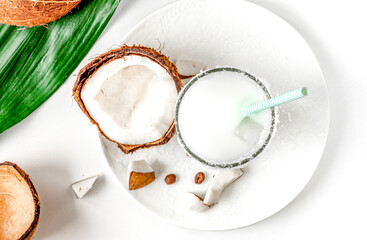 cocktail with coconut on white background top view