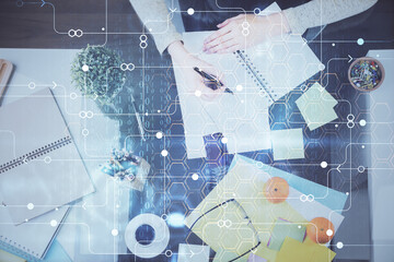 Double exposure of writing hand on background with data solution technology hologram. Ai concept.