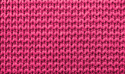 Knitted pink background. Yarn texture. Vertical knitting