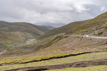 The view of destroyed tibetan road on highlands in mountains