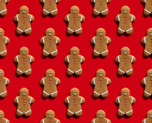 Gingerbread man pattern. Red seamless background. Bakery food art. Beige cookie with white icing creative minimalist symmetrical composition isolated on bright.