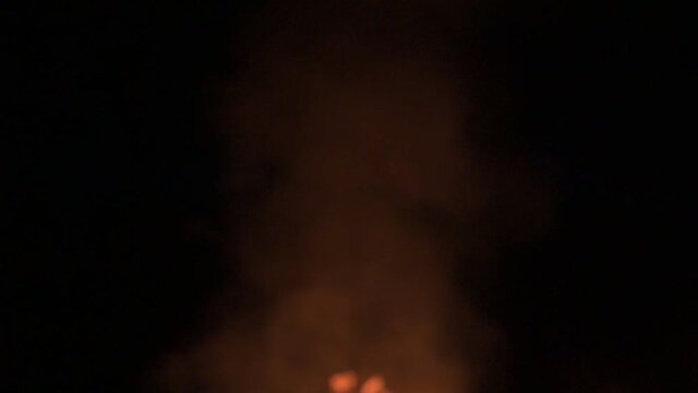 Flames and smoke late in the evening, slowing down the fire and smoke on a dark background.2020