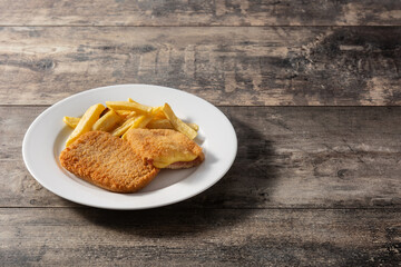 San Jacobo steak filled with cheese and ham on wooden table.Copy space