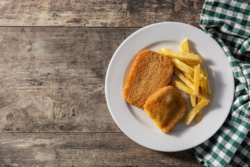 San Jacobo steak filled with cheese and ham on wooden table.Top view. Copy space