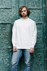 Man wearing white sweatshirt or hoodie for mock up, logo designs or design prints with with free...