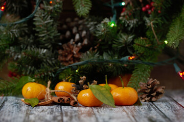 Christmas New year Composition with Tangerines Boxes Pine cones Greenery in a basket Black background Festive decoration to the Russian tradition