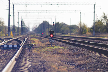 Traffic light with red light on the railway